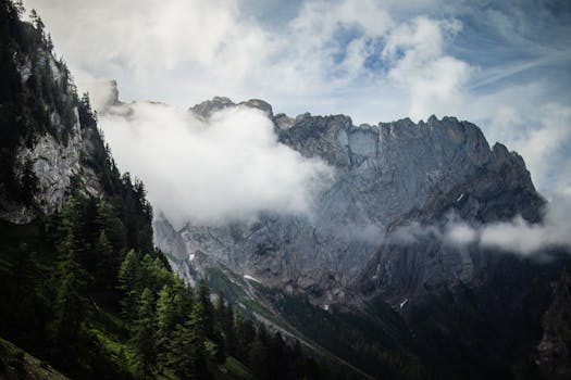 Stunning view of mountains enveloped in clouds, showcasing nature's grandeur.
